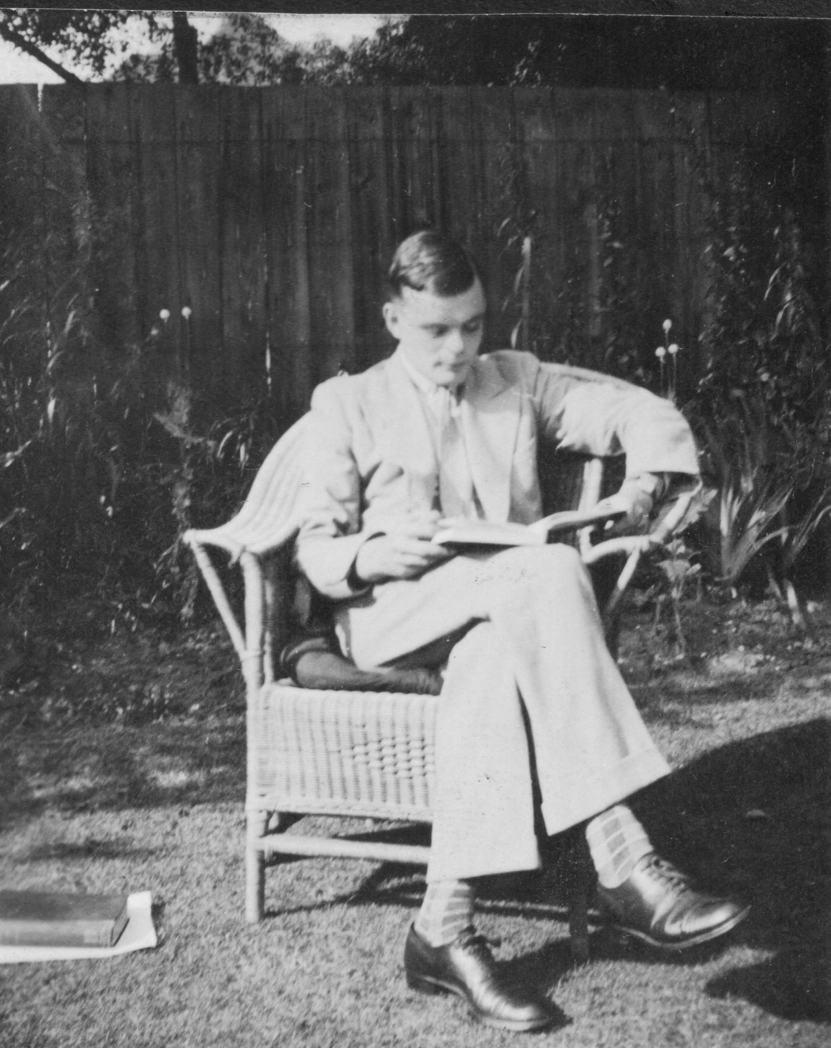 Turing reading in 1935, at his parents’ home garden. That same year, he published Equivalence of left and right almost periodicity, his first paper ever.