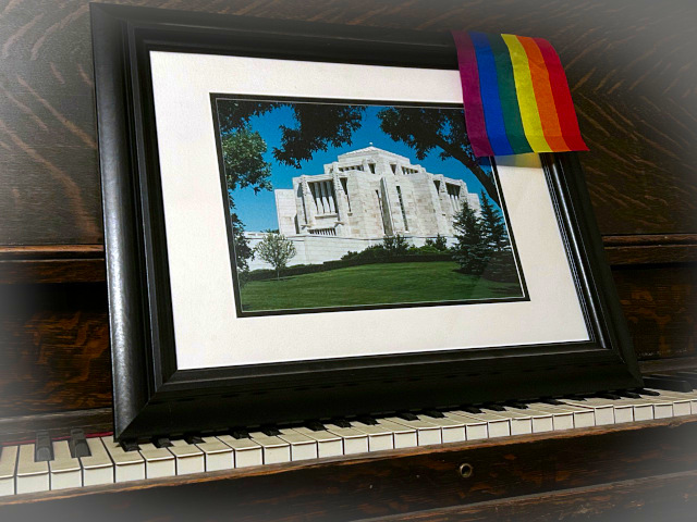 A Picture of a Framed Photo of the Cardston Alberta Temple with a small pride flag representing change can happen anywhere..