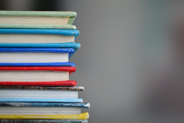 A stack of books with brightly coloured covers.