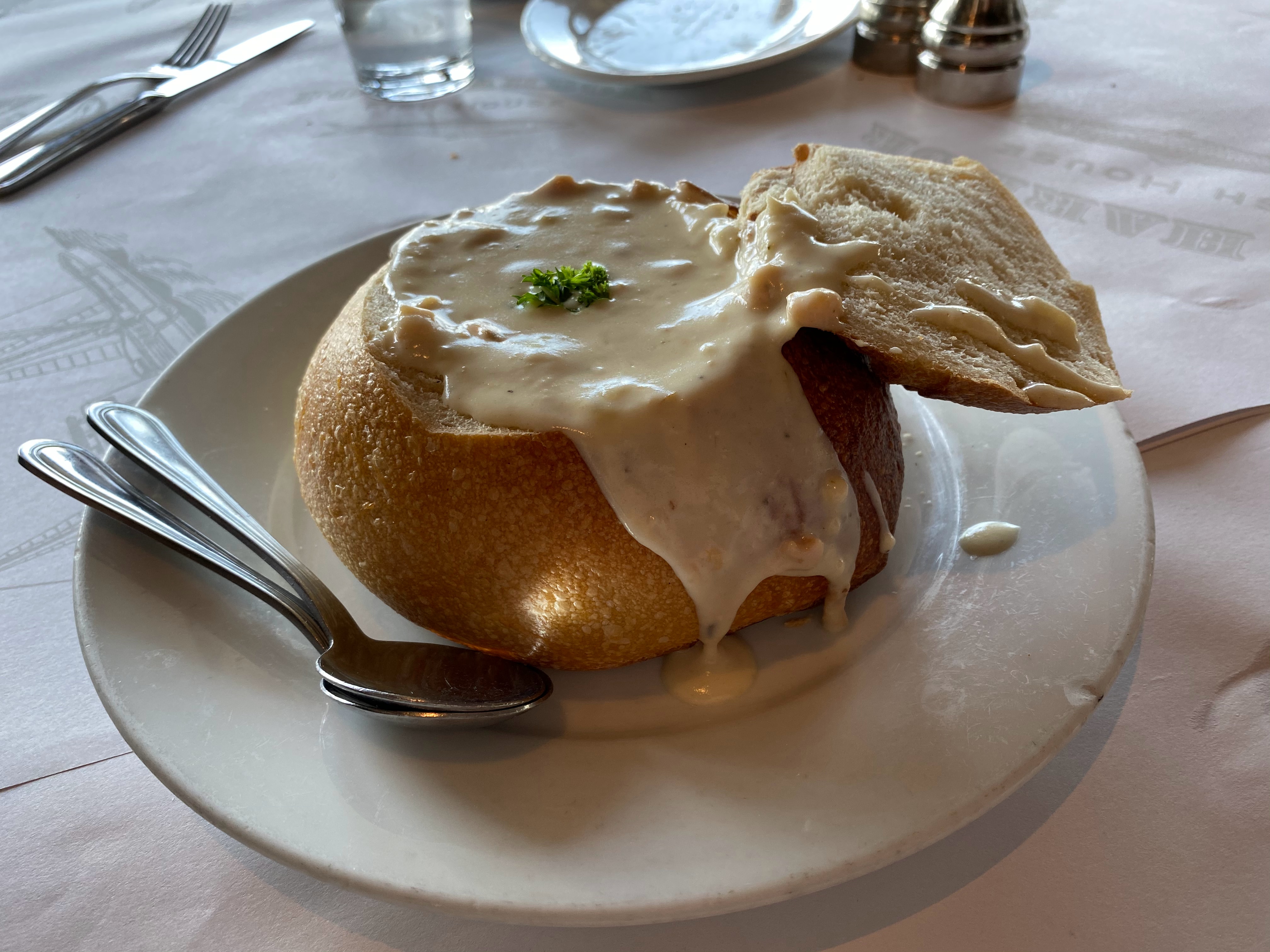 An image of a bread bowl full of Creamy Crab and Asparagus Soup..
