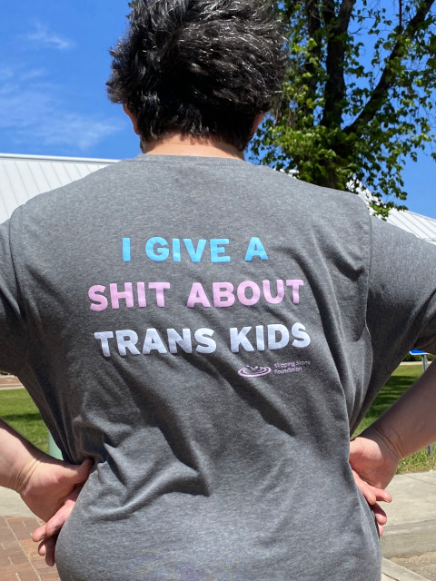 A Photo of a person wearing a shirt that Reads, I give a Shit about Trans Youth.